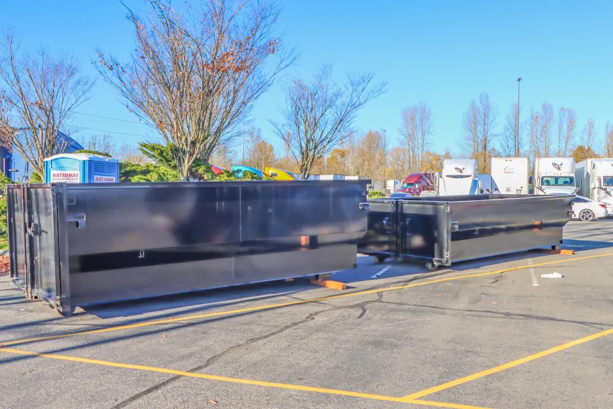 Professional dumpster rental service with roll-off container on residential driveway in Lake Havasu City